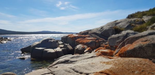 Rocks on beach against sky