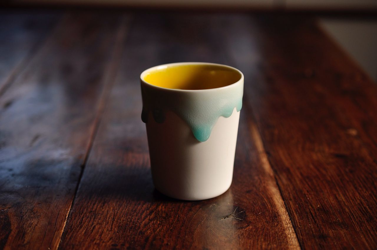 drink, refreshment, table, food and drink, still life, indoors, wood - material, freshness, close-up, coffee cup, wooden, coffee - drink, coffee, no people, single object, high angle view, beverage, focus on foreground, cup, frothy drink