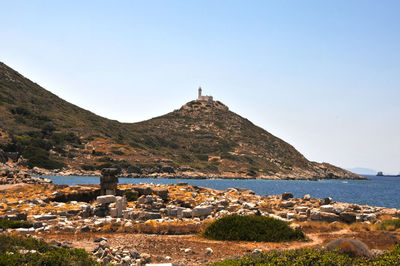 Scenic view of sea by buildings against clear sky