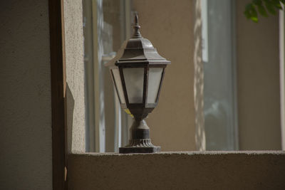 Close-up of electric lamp against wall