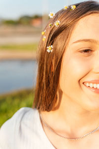 Happy teenage girl with flowers in her hair