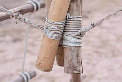 Close-up of rope tied on wooden post