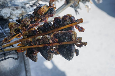 High angle view of meat on barbecue grill