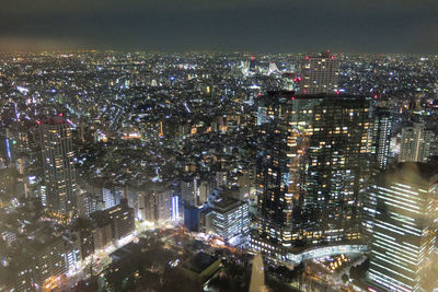 High angle view of illuminated city buildings at night