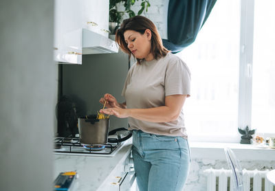 Young woman standing at home