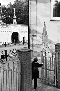 Rear view of man standing outside building