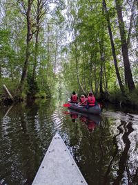 People in boat on lake in forest