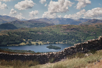 Scenic view of lake and mountains against sky