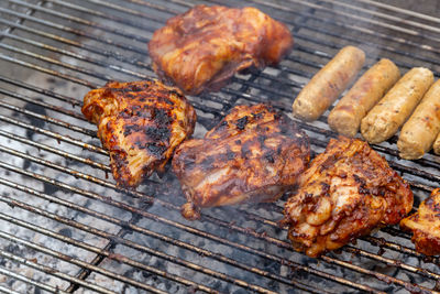 High angle view of meat on barbecue grill