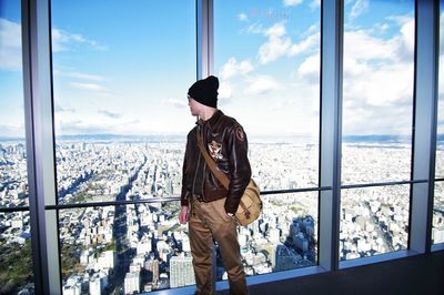 Man looking through window