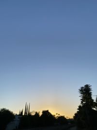 Low angle view of silhouette trees against clear sky