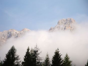 Low angle view of snowcapped mountains against sky