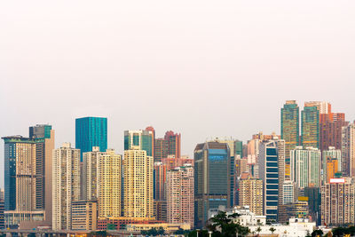 Modern buildings in city against clear sky