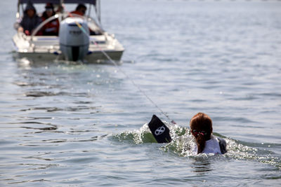 Woman waterskiing on lake