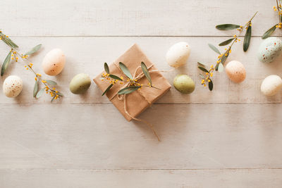 Easter garland with brown paper gifts, easter eggs and eucalyptus leaves garland and copy space