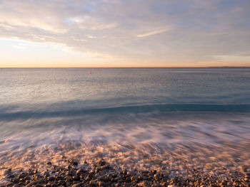 View of calm sea at sunset