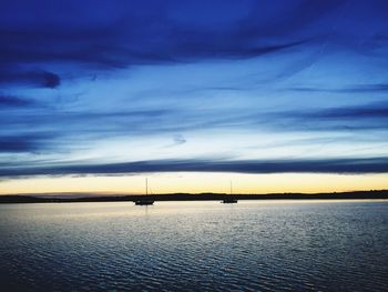 Scenic view of sea against sky at sunset