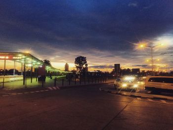 Illuminated city against sky during sunset