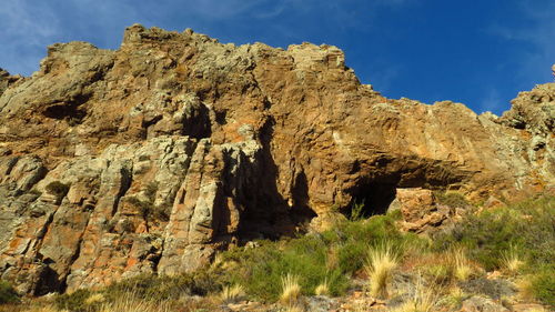 Low angle view of rock formations against sky