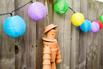 Close-up of toys hanging on wood