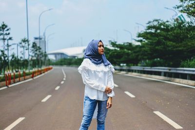 Woman wearing headscarf while on road