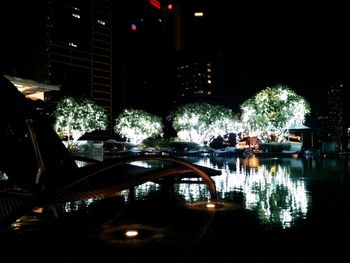 Illuminated bridge over river at night