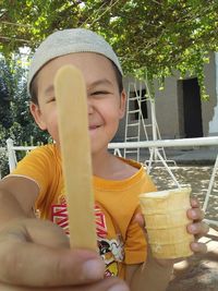 Midsection of man holding ice cream cone