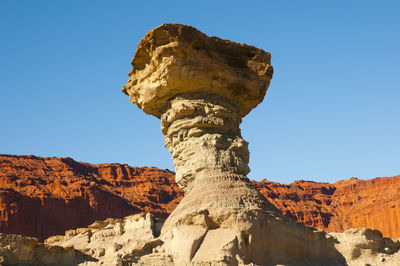 Rock formation against clear blue sky