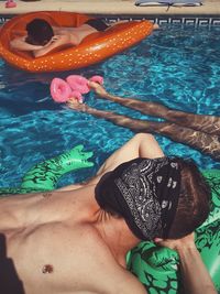 High angle view of man relaxing in swimming pool