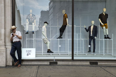 People standing on wall with city in background