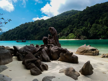 Rocks on beach against sky