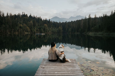 View of horse sitting on lake against sky