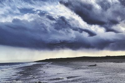 Scenic view of sea against cloudy sky