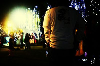 Rear view of people at night