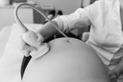 Midsection of doctor examining patient