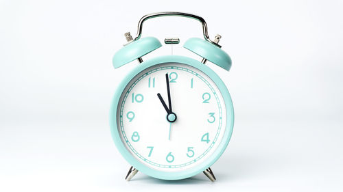 Close-up of clock over white background