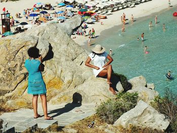 High angle view of people at beach during sunny day