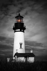 Lighthouse against sky at night