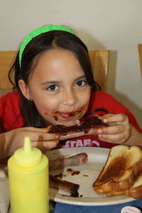 Portrait of cute girl eating food