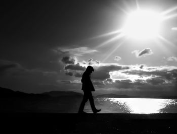 Silhouette of people standing at sunset