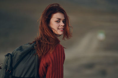 Portrait of smiling young woman standing outdoors