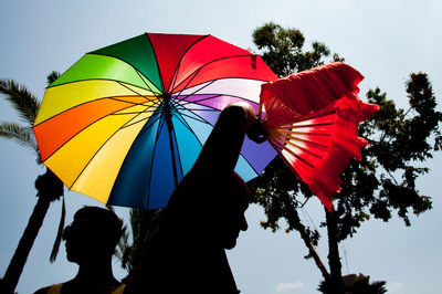 Low angle view of multi colored balloons against sky