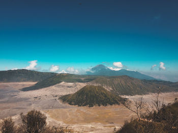 Scenic view of landscape against blue sky