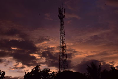 Low angle view of communications tower against sky during sunset