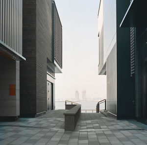 Empty alley amidst buildings in city