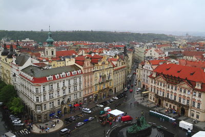 High angle view of vehicles on road amidst buildings in city