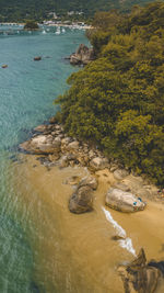 High angle view of rocks on sea shore