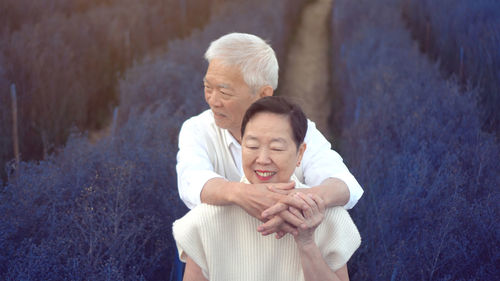 Rear view of couple holding hands