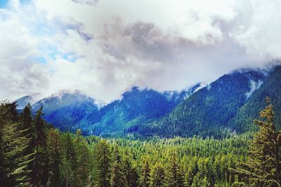 Scenic view of mountains against cloudy sky
