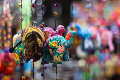 Close-up of decorations hanging for sale in market